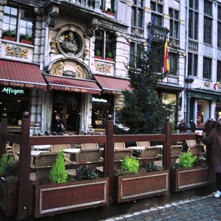 Exterior of a restaurant with a decorated Christmas tree.