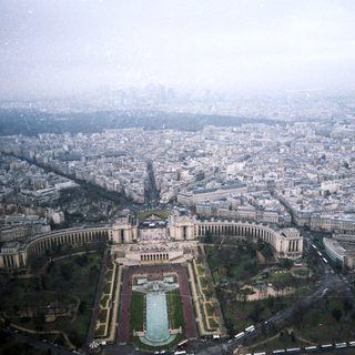 Aerial view of a grand Parisian plaza and cityscape.