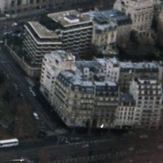 Aerial view of a grand Parisian plaza and cityscape.