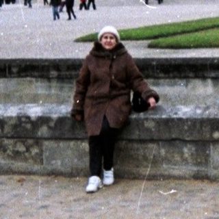 Person standing near the Arc de Triomphe in Paris.