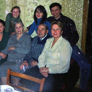 Family gathered indoors, appearing to be a formal portrait.