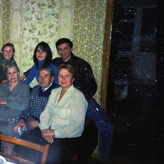 Family gathered indoors, appearing to be a formal portrait.