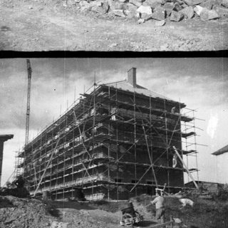 Construction of a multi-story building with scaffolding and stonework.