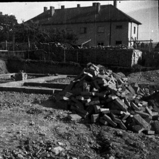 Construction debris near houses, possibly a demolition site.