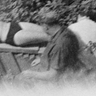 Man performing a gymnastics routine outdoors, possibly a vault.