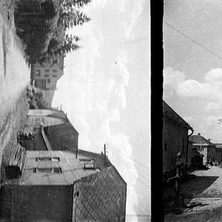 Here's a brief summary: Historic street scene with buildings, cobblestone, and a well.