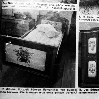 Black and white image showcases vintage furniture and room decor.