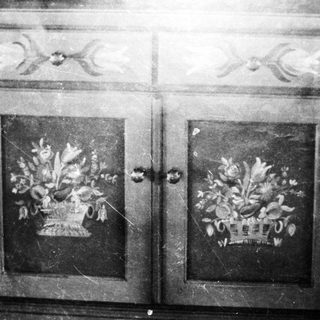 Antique cabinet doors with floral designs, in black and white.