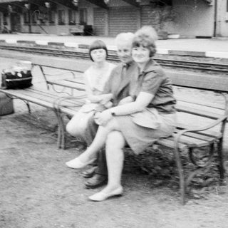 Black and white photo of people near a train platform.