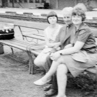 Black and white photo of people near a train platform.
