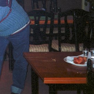 Men and a woman in a restaurant interior.