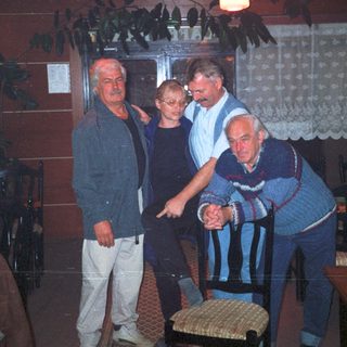 Men and a woman in a restaurant interior.