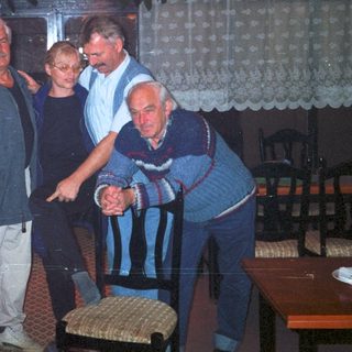 Men and a woman in a restaurant interior.