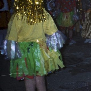 Children in costumes perform on a stage with decorations.