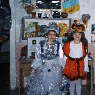 Children in costumes perform in a classroom setting.