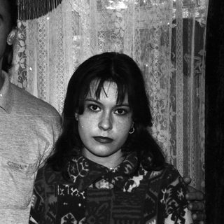 Black and white portrait of a couple standing indoors.
