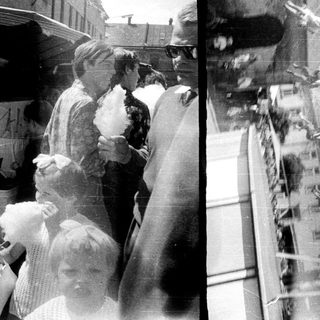 Here's a brief summary of the image: People line up for cotton candy at a fair.
