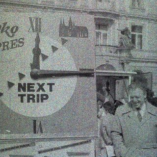 Black and white image showing a building and a sign.