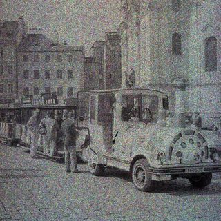 Vintage bus parked on a street with buildings.