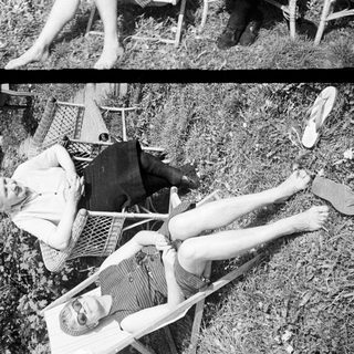 Two women relaxing in chairs outdoors in a garden.