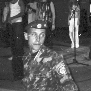 Group of people on stage, possibly a band or performance.