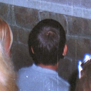 Audience viewing a stage performance at night.