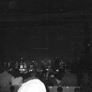 Crowd watching a performance on a stage.