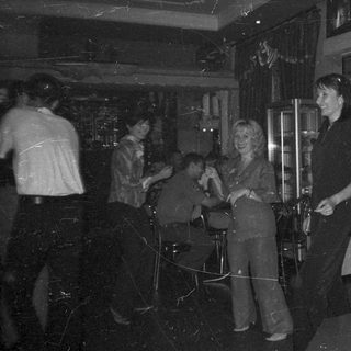 People socializing indoors, possibly at a party or event.