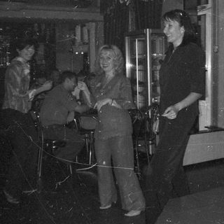 People socializing indoors, possibly at a party or event.