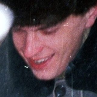 Child in winter coat is being carried through snow.