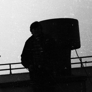 Silhouette of a person standing on a rooftop.