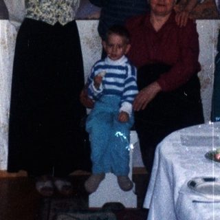 Family portrait in a dining room with a long table.