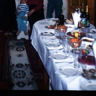 Family portrait in a dining room with a long table.