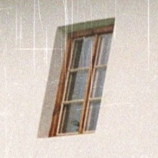 Stone and wood building with rain, barrels visible.