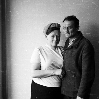 Black and white portrait of a couple standing close together.
