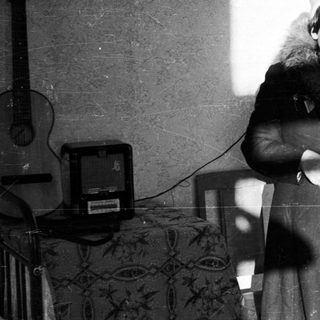 Woman stands in a room, illuminated by strong light.