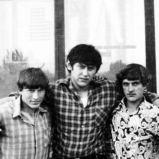 Three men pose for a black and white photograph.
