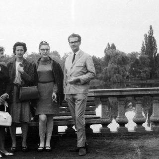 Group portrait of four people near a body of water.