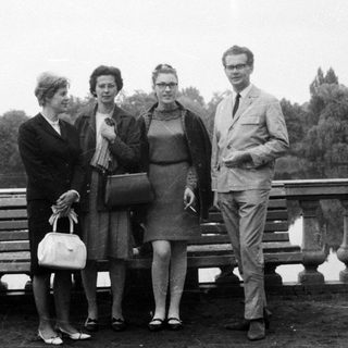 Group portrait of four people near a body of water.