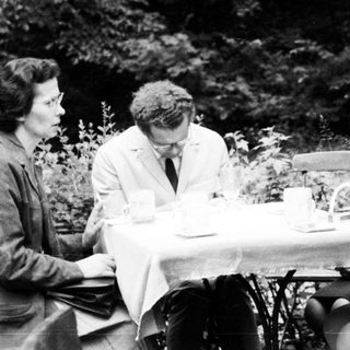 Four people seated at a table outdoors.