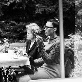 Four people seated at a table outdoors.