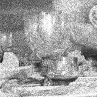 Three people seated at a table, possibly dining.