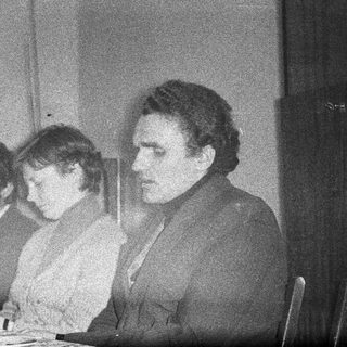 Three people seated at a table, possibly dining.