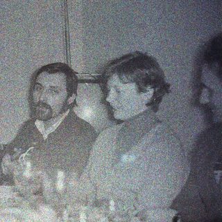 Two men seated at a table, appearing to be dining.