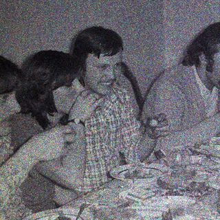 Group of people dining together at a table.