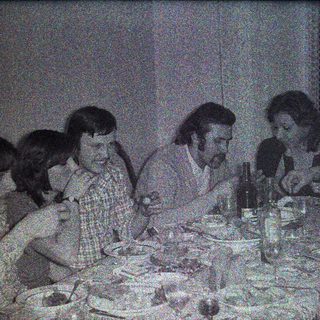 Group of people dining together at a table.