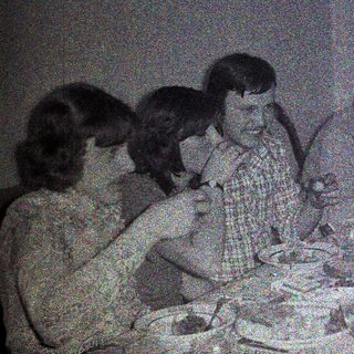 Group of people dining together at a table.