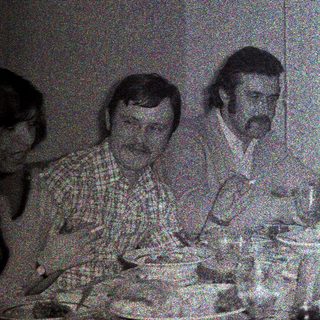 Group seated around a table, appearing to be dining.