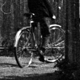 Black and white image of a house with a bicycle.