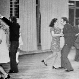 People dancing indoors, possibly at a party or event.